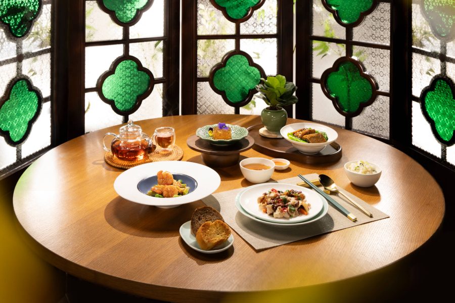 A spread of dishes by Cathay Pacific's inflight dining partner Duddell's. The various dishes include shredded chicken with celtuce and wood ear mushrooms, wok-fried prawns with spring onions and bird's eye chilli, and osmanthus and oolong tea jelly.